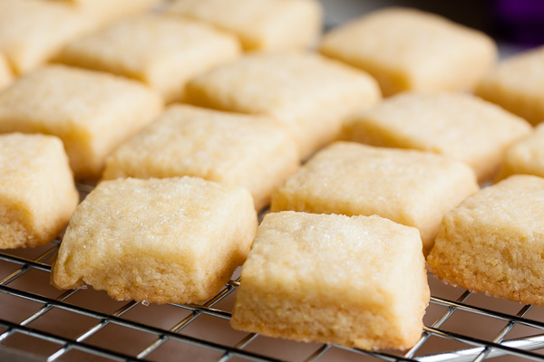 This tiny lemon shortbread cookie is soft and tender and buttery. A lovely variation on traditional shortbread.