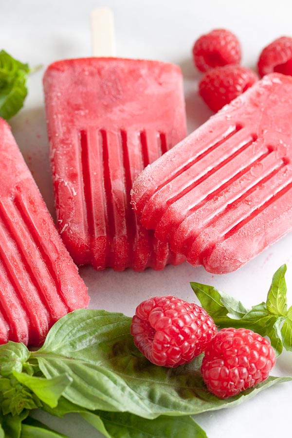 Raspberry Basil Popsicles. All the lovely tart, sweet flavour of raspberries, cut slightly by spicy, earthy basil.