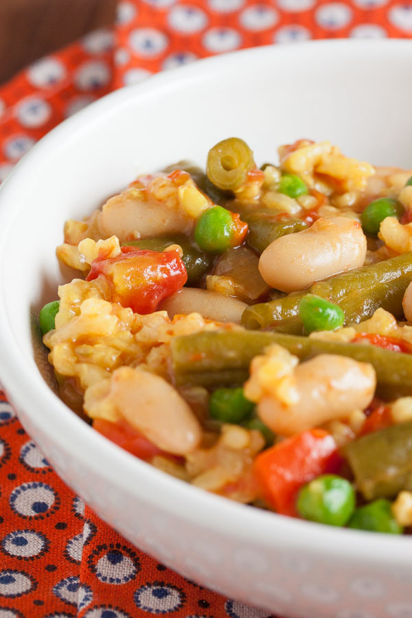 Brightly coloured vegetarian paella – a delicious and filling blend of rice, vegetables, and legumes.